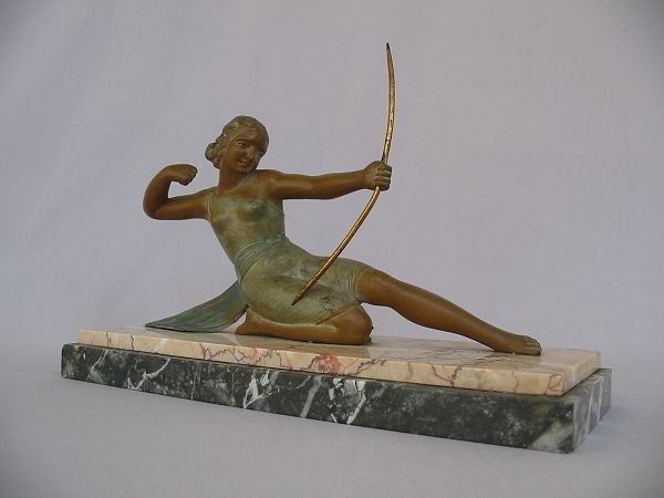 Art deco bronze patinated cast metal figure on marble.