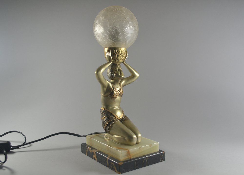 Art deco figural lamp. Lady holding a ball.