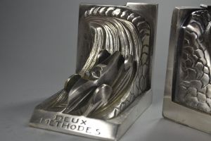 Race car against snail. Silver plated bookends. 